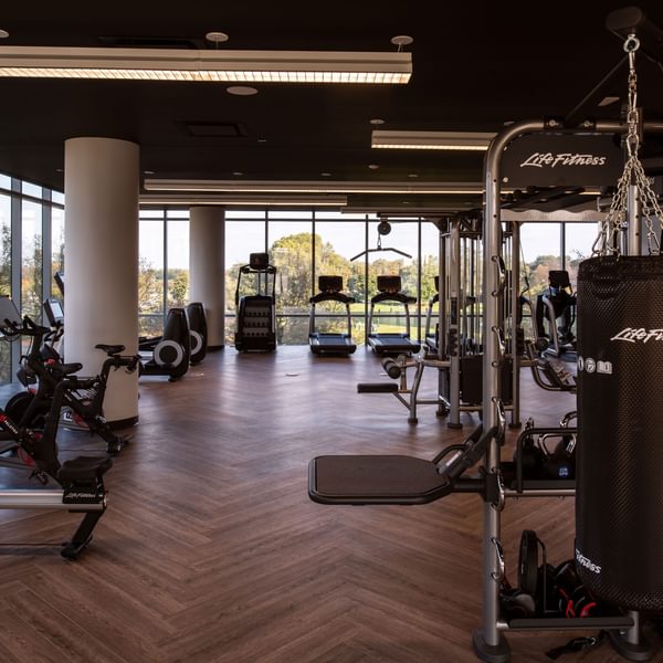 Pet-Friendly Apartments in Uptown Chicago, IL - Eight Eleven Uptown - Fitness Center with CardioMachines, Weight-Lifting Machines, and Floor-to-Ceiling Windows.